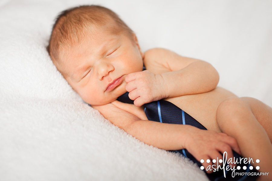 Newborn photo with a tie in Cedar Rapids